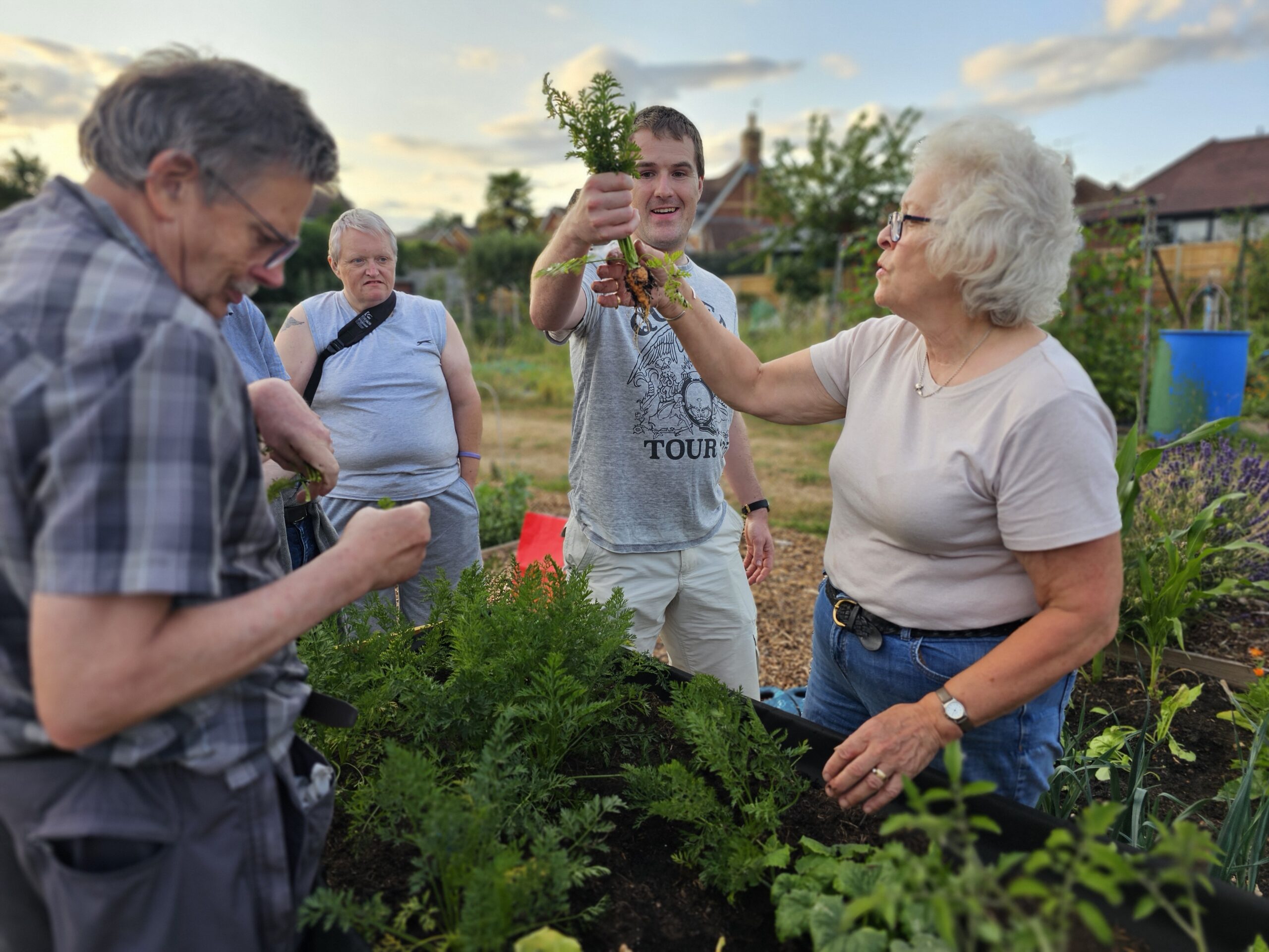Member of our community lifting a carrot
