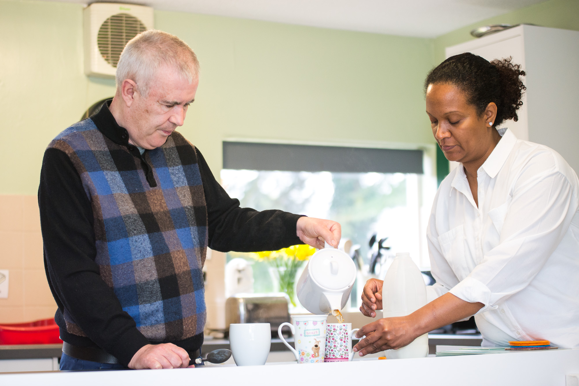 Learning to pour hot water safely with a Support Worker.