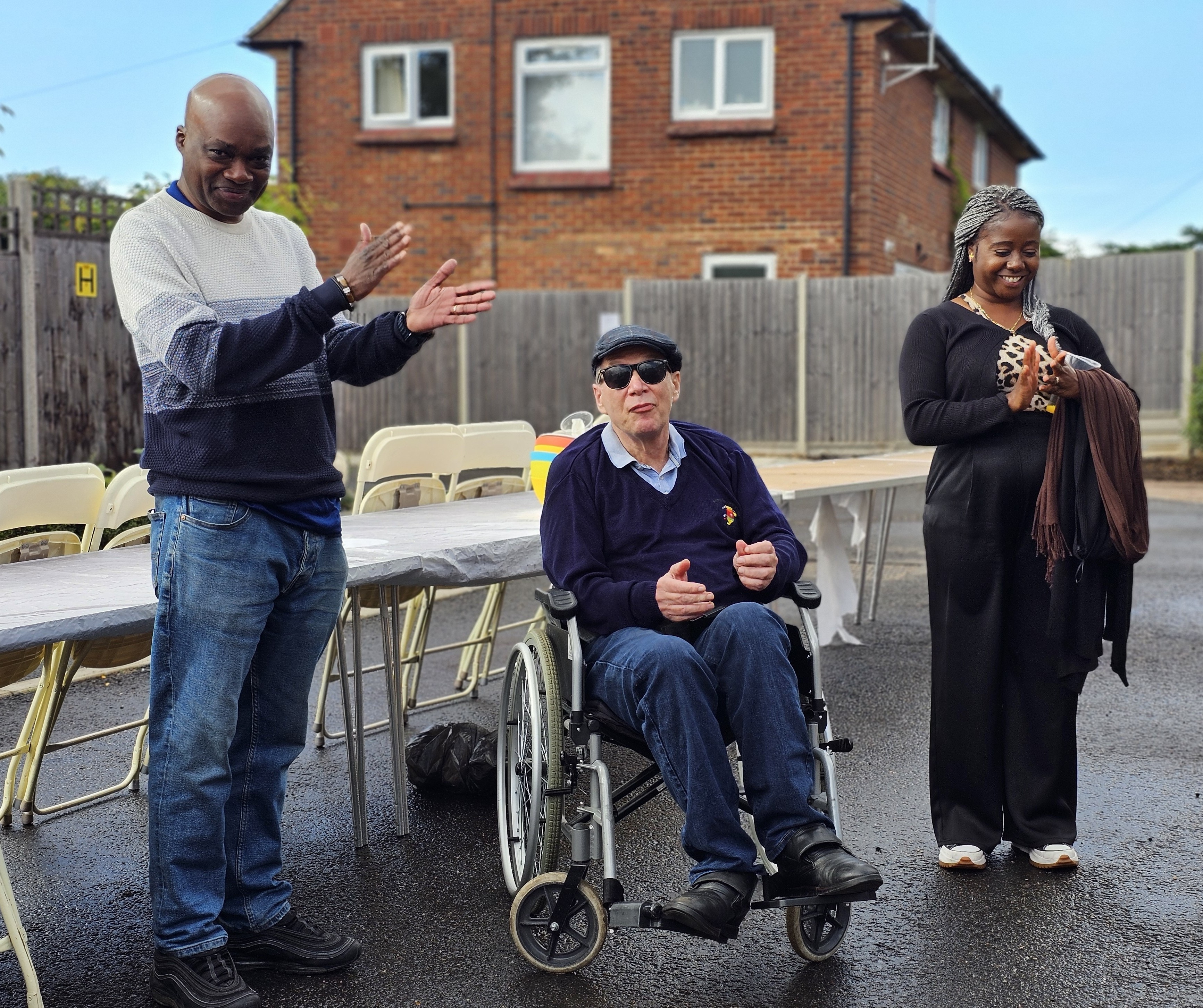 Wheelchair user celebrating with Support Workers at our Street Party.
