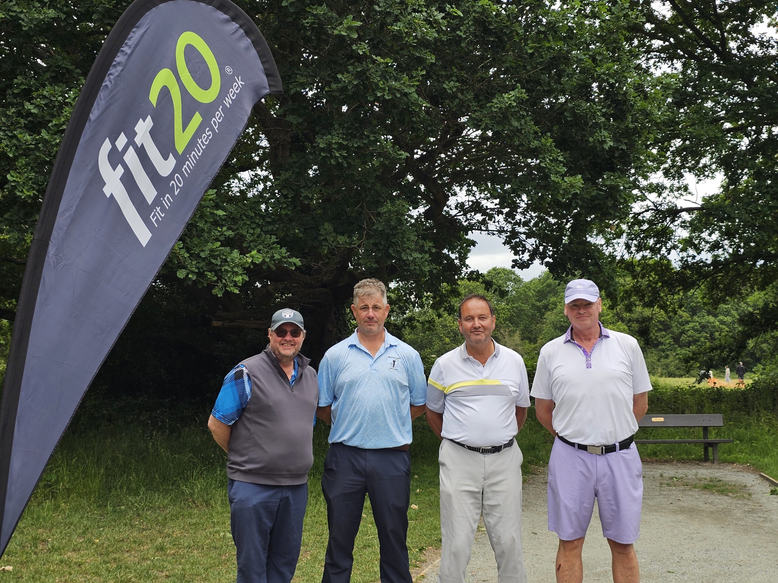 Higginson Irregulars team beside the fit20 hole sponsor flag