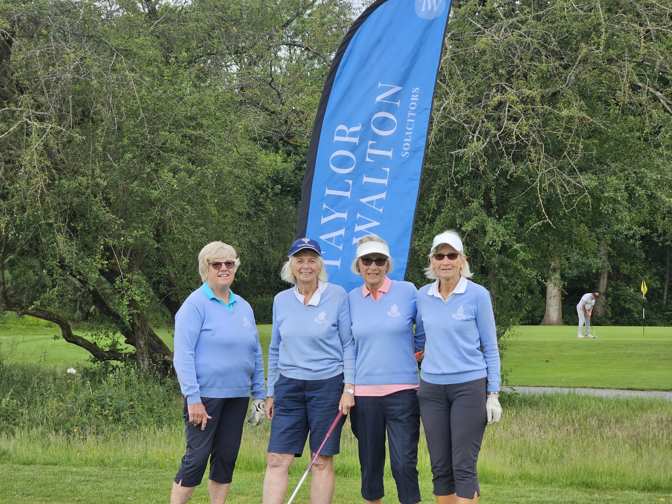 The Common Girls with the Taylor Walton Solicitors flag