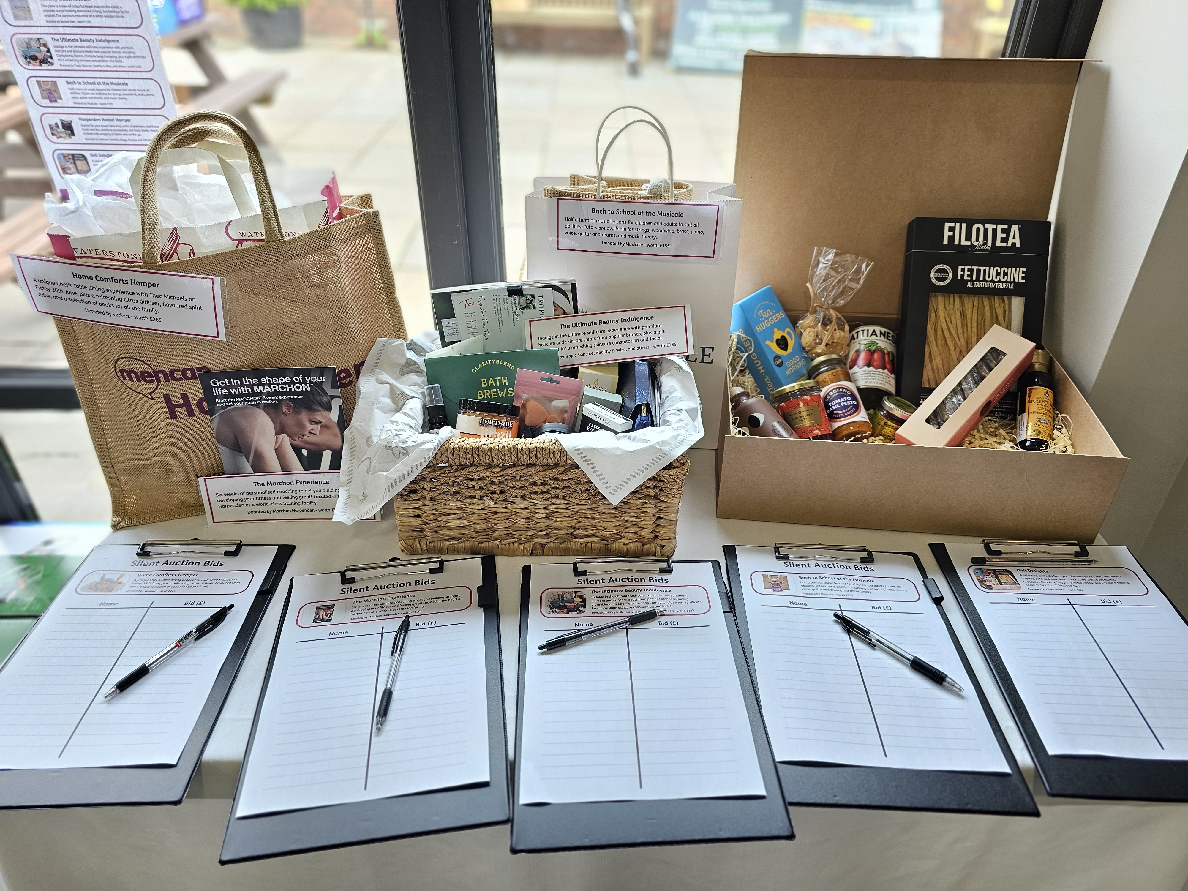 Clipboards and pens with the auction prizes