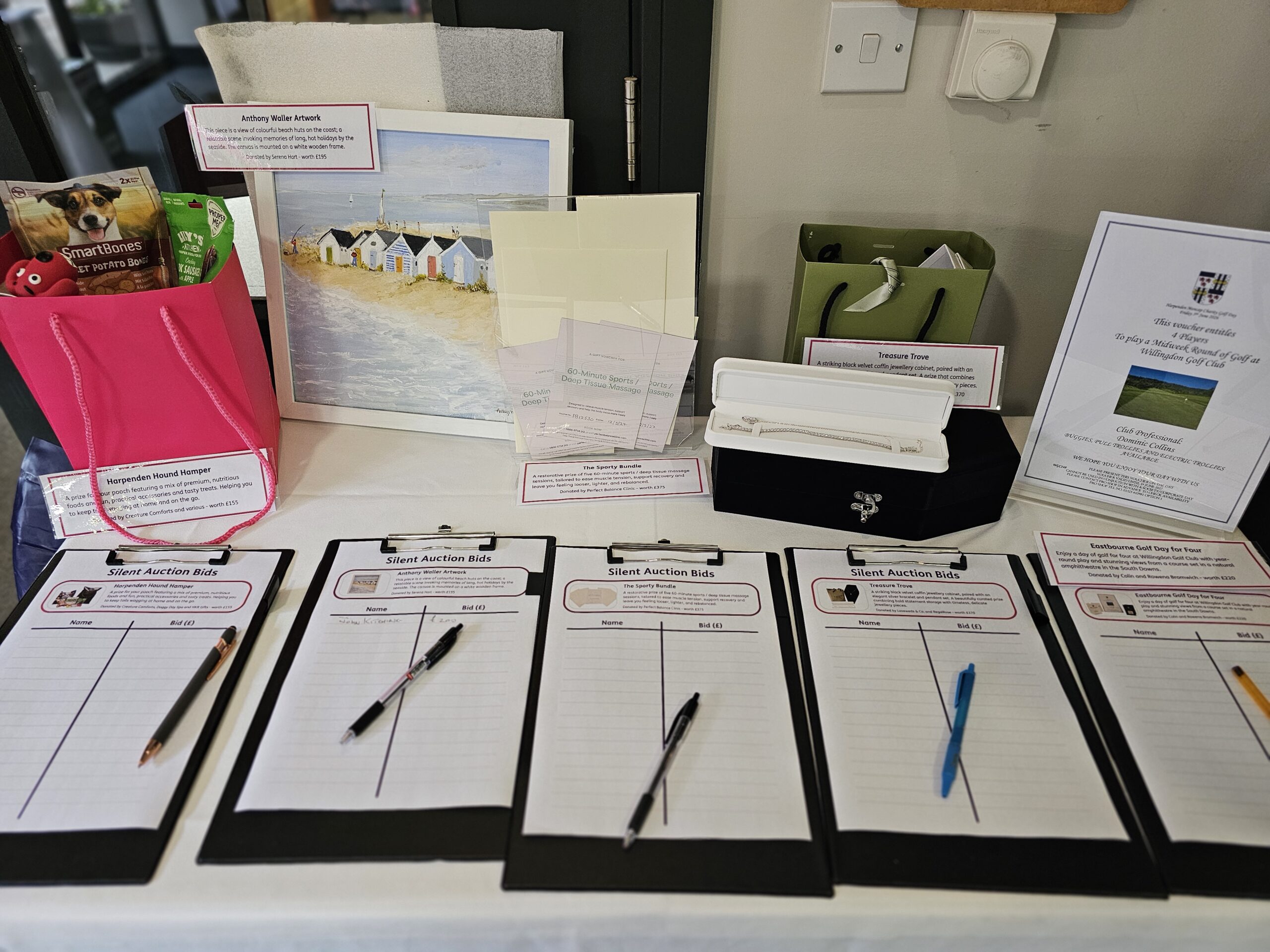 Clipboards and pens with the auction prizes